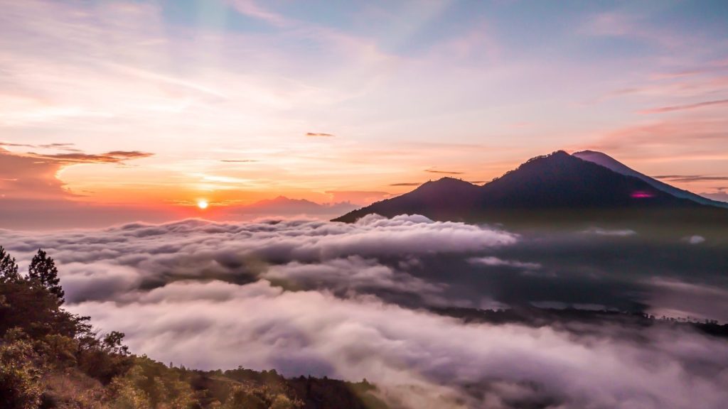 Sunrise over Mount Batur volcano and mountains in Bali